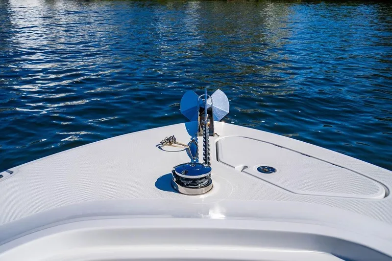 Slide: The Image of Bow of 2024 HCB 42 Lujo boat with anchor, on calm blue water. - 58