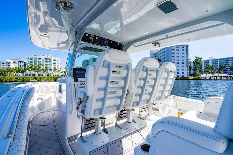 Slide: The Image of Luxurious 2024 HCB 42 Lujo boat interior with plush seating, docked near waterfront buildings. - 65