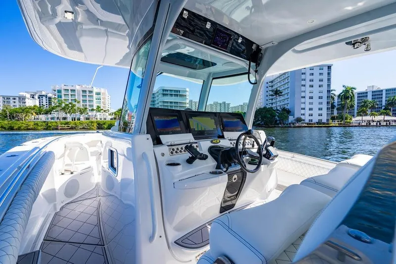 Slide: The Image of 2024 HCB 42 Lujo boat interior with modern dashboard and waterfront view. - 66