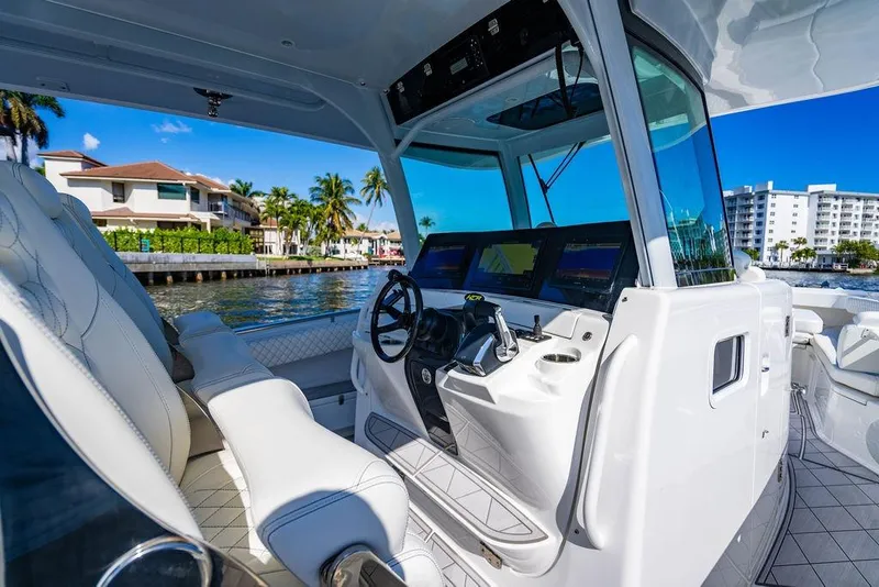 Slide: The Image of 2024 HCB 42 Lujo boat interior with modern helm, luxury seating, and waterfront view. - 67