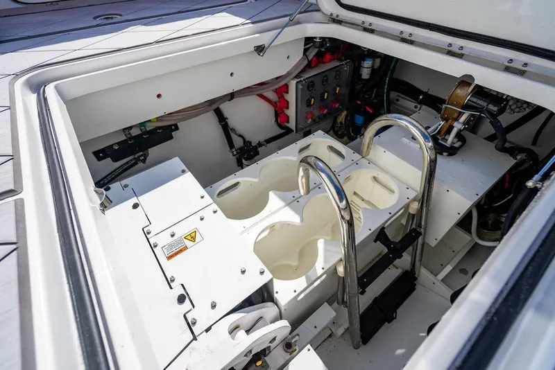 Slide: The Image of Engine compartment of 2024 HCB 42 Lujo boat, showcasing mechanical components and controls. - 70