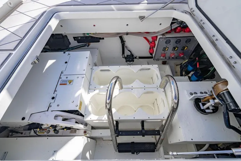 Slide: The Image of 2024 HCB 42 Lujo boat engine compartment with control panel and storage. - 71