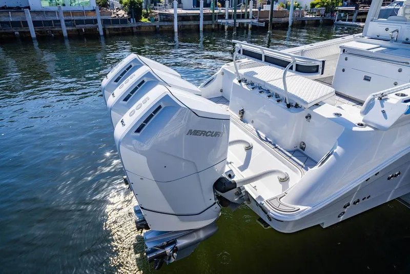 Slide: The Image of 2024 HCB 42 Lujo boat with triple Mercury outboard engines on water. - 77