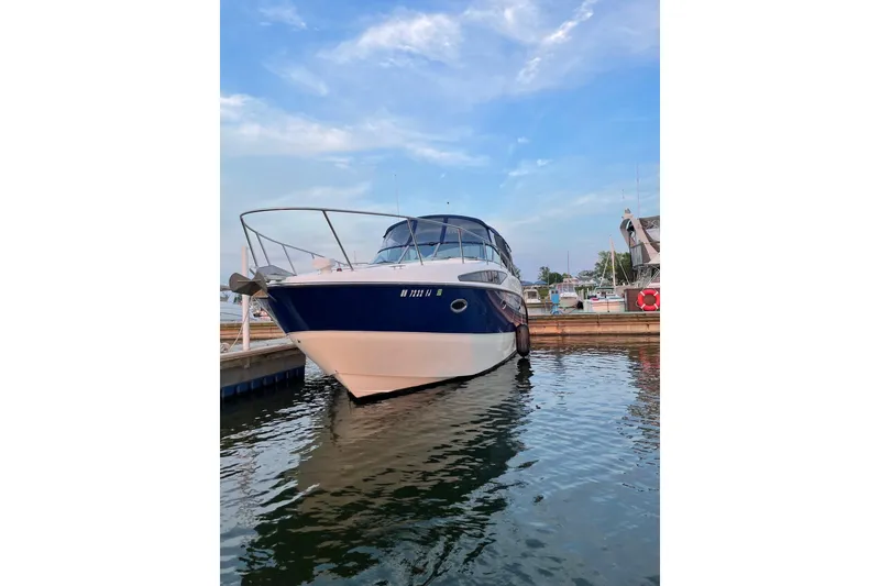 Slide: The Image of 2007 Bayliner 325 boat docked in marina under blue sky. - 5