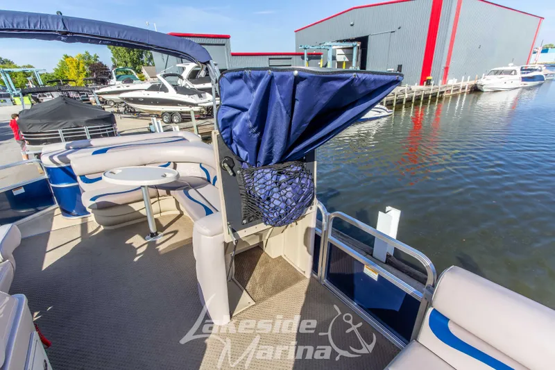 Slide: The Image of 2013 SunChaser DS22 pontoon boat at marina, featuring seating and water view. - 13