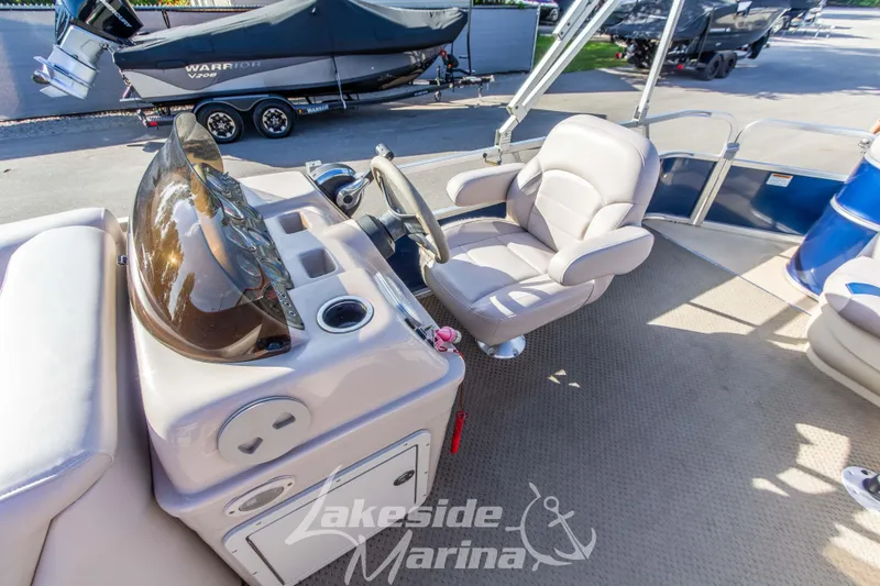 Slide: The Image of 2013 SunChaser DS22 boat interior with steering console and captain's chair at Lakeside Marina. - 14