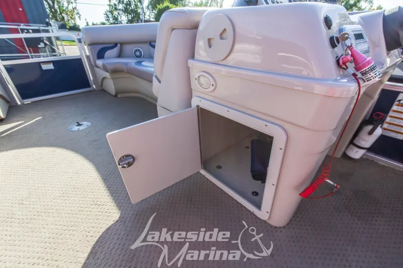 Slide: The Image of Interior of 2013 SunChaser DS22 boat with open storage compartment and seating area. - 15