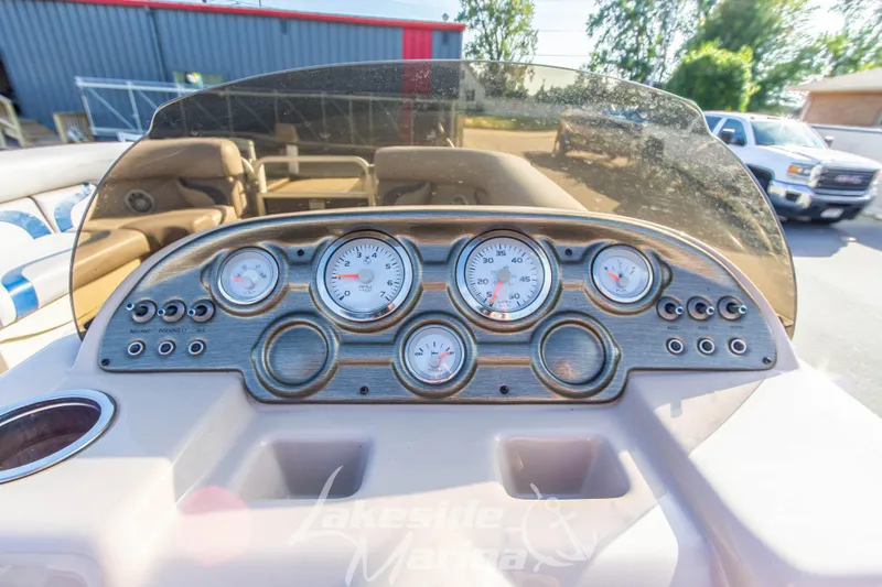 Slide: The Image of Dashboard of 2013 SunChaser DS22 boat with gauges and controls, outdoor setting. - 17
