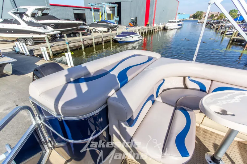 Slide: The Image of 2013 SunChaser DS22 pontoon boat with stylish seating at a marina dock. - 20