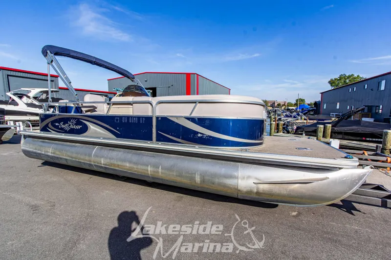 Slide: The Image of 2013 SunChaser DS22 pontoon boat at Lakeside Marina, blue and silver design. - 3
