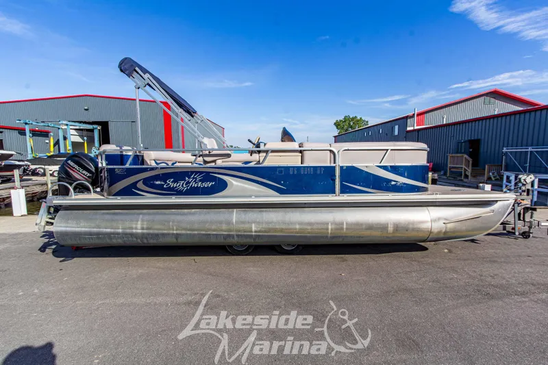 Slide: The Image of 2013 SunChaser DS22 pontoon boat at Lakeside Marina, featuring a Mercury outboard motor. - 4