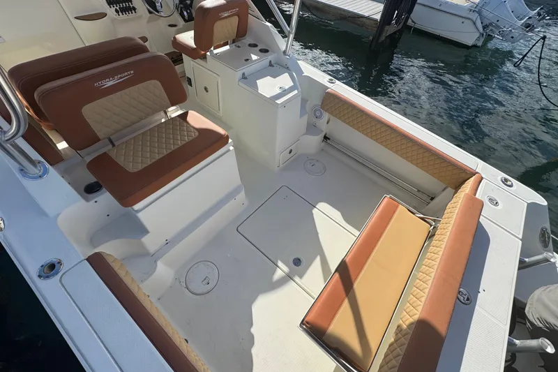 Slide: The Image of 2011 Hydra-Sports 3000 VX boat interior with cushioned seating and storage compartments. - 11
