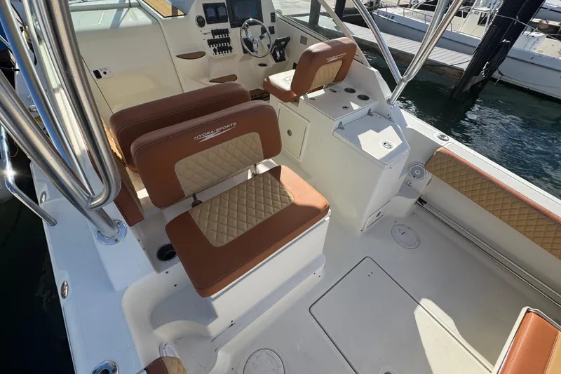 Slide: The Image of 2011 Hydra-Sports 3000 VX boat interior with cushioned seating and control panel. - 12