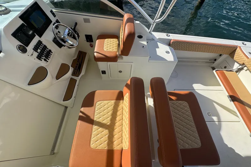 Slide: The Image of 2011 Hydra-Sports 3000 VX boat interior with tan leather seating and modern dashboard. - 13