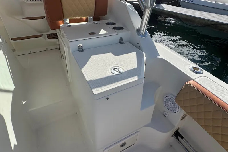 Slide: The Image of 2011 Hydra-Sports 3000 VX boat interior with seating and storage, docked by the water. - 15