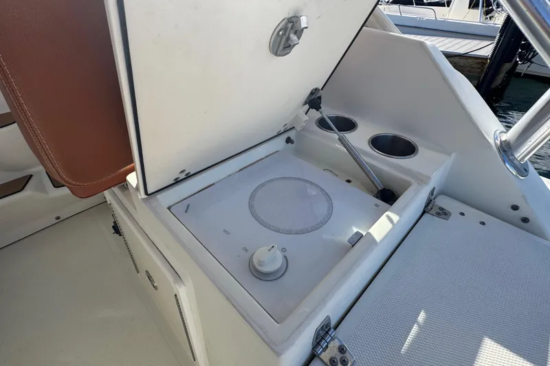 Slide: The Image of 2011 Hydra-Sports 3000 VX boat interior with built-in stove and cup holders. - 16