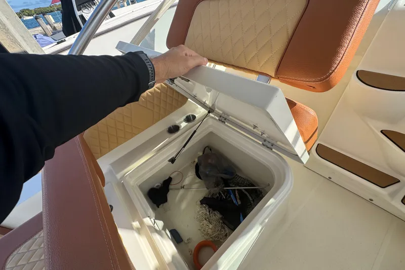 Slide: The Image of 2011 Hydra-Sports 3000 VX boat storage compartment with fishing gear and accessories. - 19