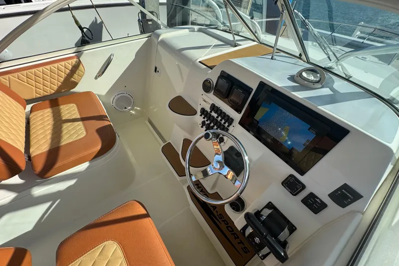 Slide: The Image of 2011 Hydra-Sports 3000 VX boat cockpit with modern controls and tan seating. - 23
