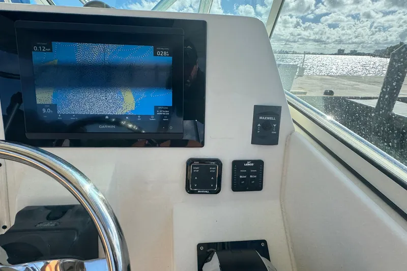 Slide: The Image of 2011 Hydra-Sports 3000 VX boat dashboard with Garmin navigation display. - 27