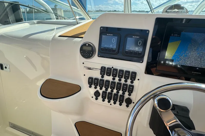 Slide: The Image of Control panel of a 2011 Hydra-Sports 3000 VX boat with navigation and engine displays. - 28