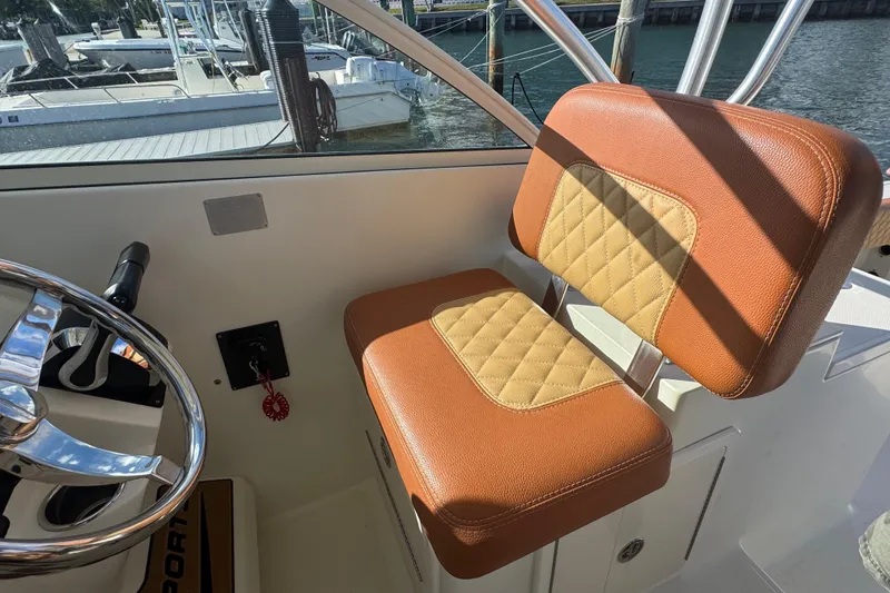 Slide: The Image of 2011 Hydra-Sports 3000 VX boat interior with tan and brown seating, steering wheel visible. - 30