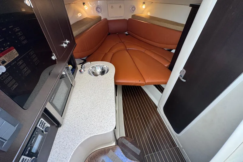Slide: The Image of 2011 Hydra-Sports 3000 VX cabin interior with kitchenette and seating area. - 36