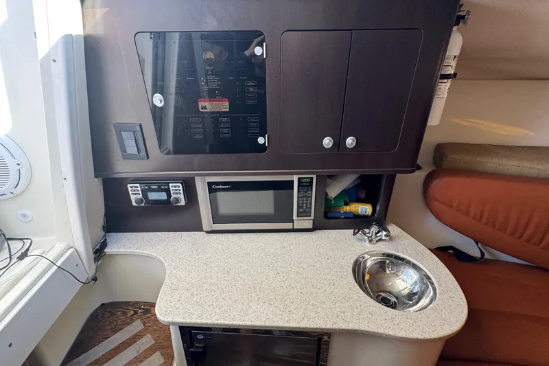 Slide: The Image of 2011 Hydra-Sports 3000 VX cabin interior with microwave, sink, and control panel. - 41