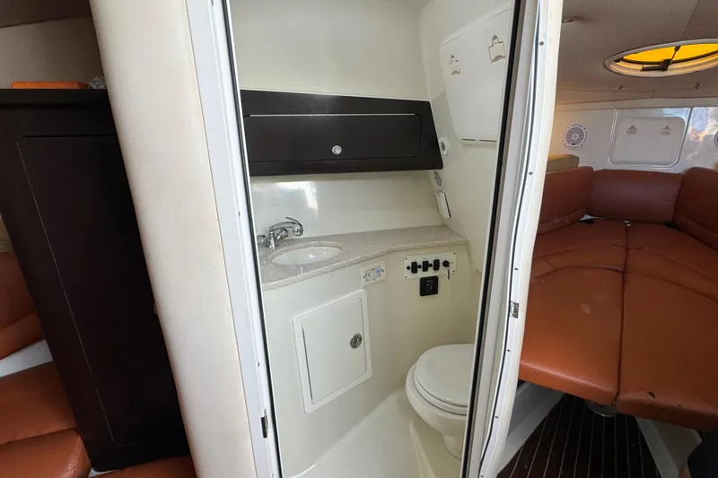 Slide: The Image of 2011 Hydra-Sports 3000 VX boat interior with compact bathroom and seating area. - 44