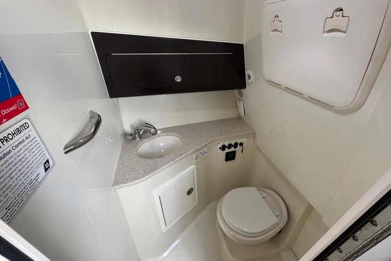 Slide: The Image of 2011 Hydra-Sports 3000 VX boat bathroom with sink, toilet, and storage cabinet. - 46