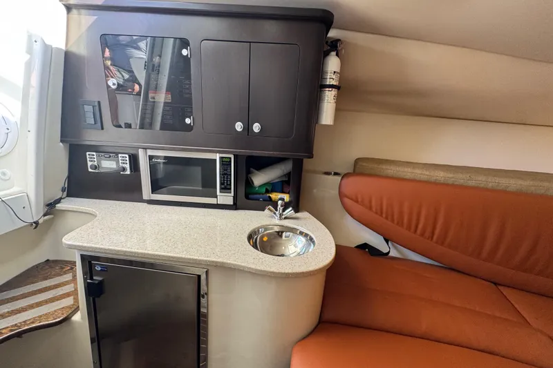 Slide: The Image of 2011 Hydra-Sports 3000 VX cabin with kitchenette, microwave, sink, and seating area. - 49