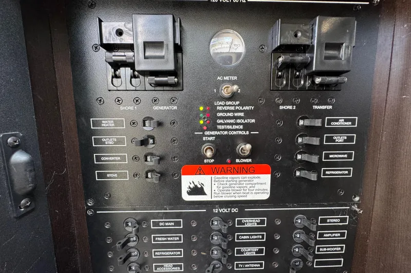 Slide: The Image of Electrical control panel of 2011 Hydra-Sports 3000 VX boat with various switches and warning label. - 51
