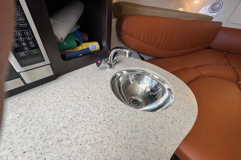 Slide: The Image of 2011 Hydra-Sports 3000 VX interior with sink, microwave, and leather seating. - 53