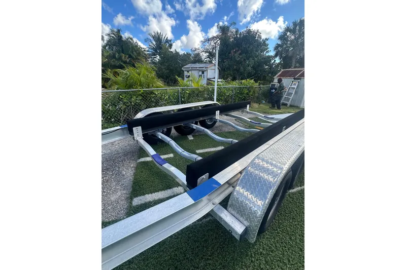 Slide: The Image of Trailer for 2011 Hydra-Sports 3000 VX boat, parked on grass with trees in background. - 57