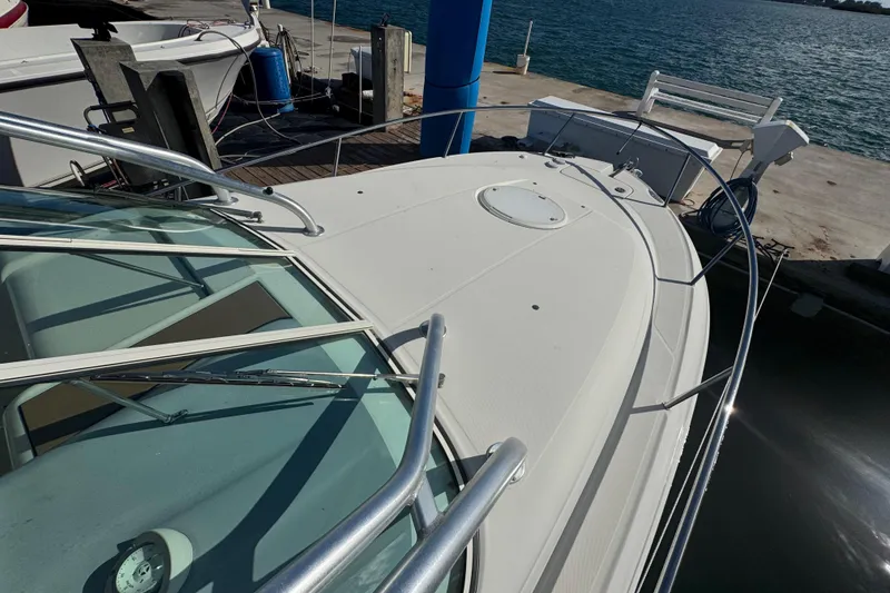 Slide: The Image of 2011 Hydra-Sports 3000 VX boat docked at marina, showcasing sleek deck design. - 7