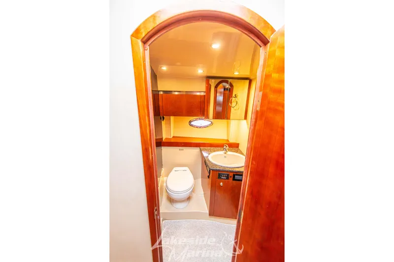 Slide: The Image of Luxurious bathroom in 2006 Cruisers Yachts 420 Express with wood accents and modern fixtures. - 103