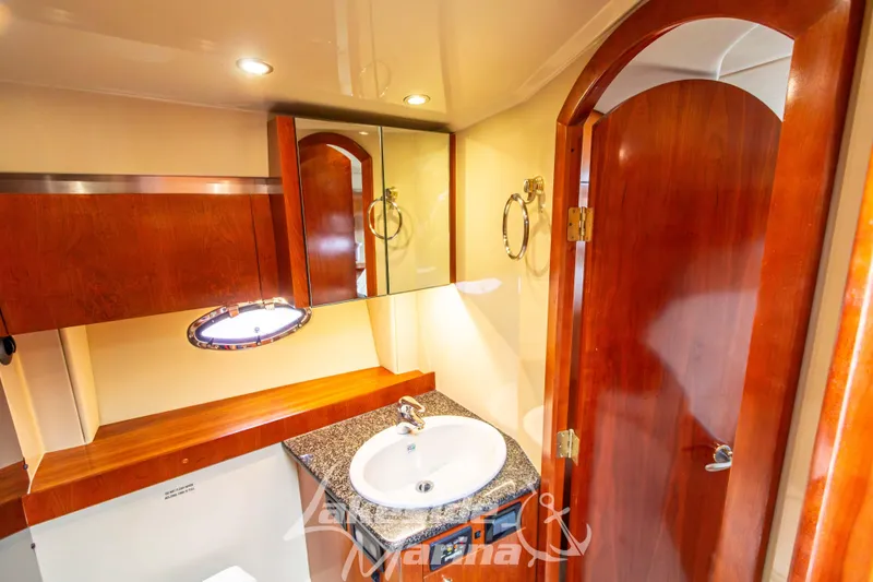 Slide: The Image of Luxurious bathroom interior of 2006 Cruisers Yachts 420 Express with wood accents and modern fixtures. - 105