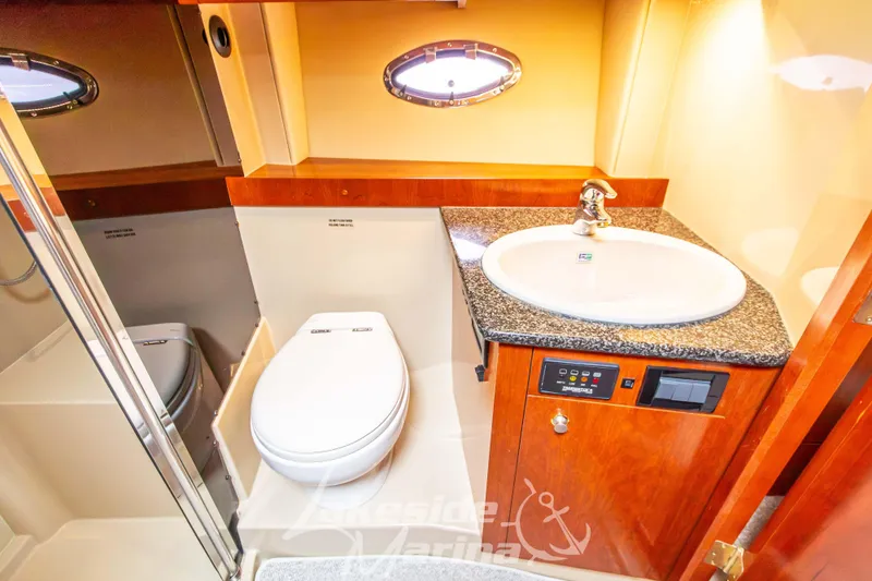 Slide: The Image of Luxurious bathroom in 2006 Cruisers Yachts 420 Express with modern fixtures and wood accents. - 106