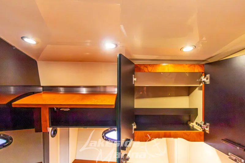 Slide: The Image of Interior of 2006 Cruisers Yachts 420 Express with open wooden cabinets and recessed lighting. - 107