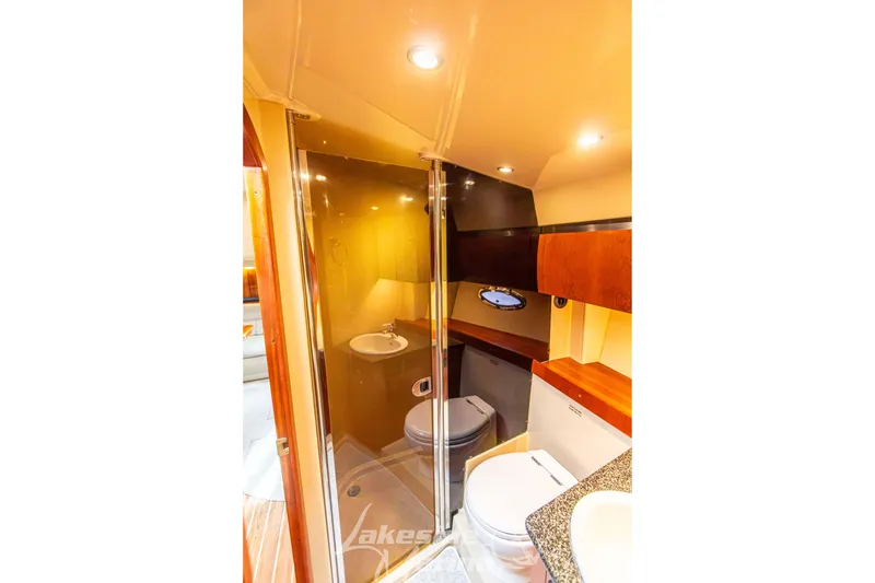 Slide: The Image of Luxurious bathroom in 2006 Cruisers Yachts 420 Express with modern fixtures and wood accents. - 108