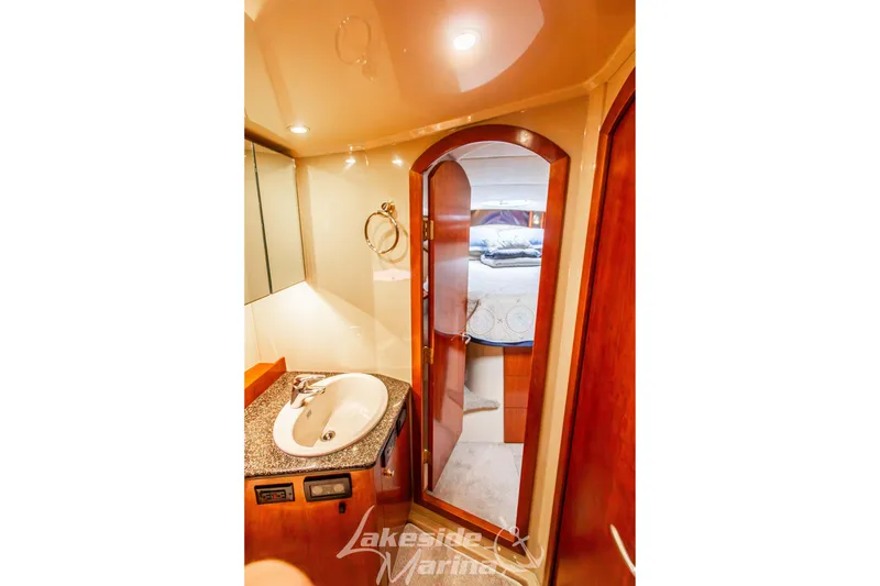 Slide: The Image of 2006 Cruisers Yachts 420 Express bathroom with sink and cabin view. - 110