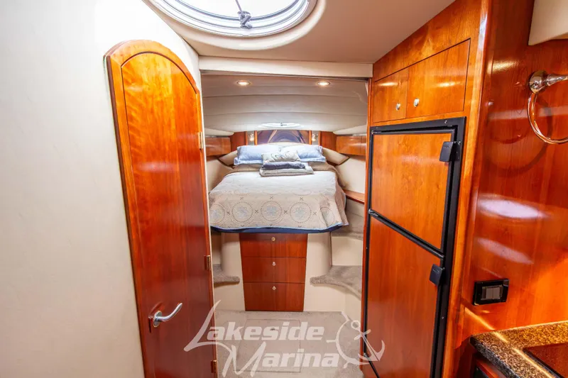 Slide: The Image of Luxurious 2006 Cruisers Yachts 420 Express cabin interior with wood finish and cozy bed. - 111
