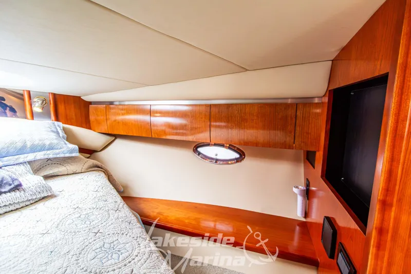 Slide: The Image of Luxurious cabin interior of 2006 Cruisers Yachts 420 Express with wood finish and bedding. - 118
