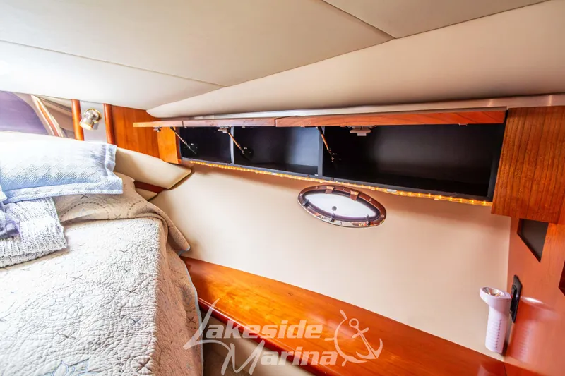 Slide: The Image of Luxurious interior of 2006 Cruisers Yachts 420 Express with cozy bedding and elegant wood finishes. - 119