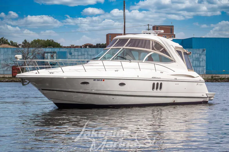 Slide: The Image of 2006 Cruisers Yachts 420 Express on water, showcasing sleek design and luxury features. - 12