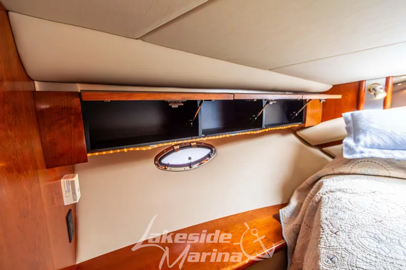 Slide: The Image of Interior of 2006 Cruisers Yachts 420 Express with wood cabinetry and cozy bedding. - 121