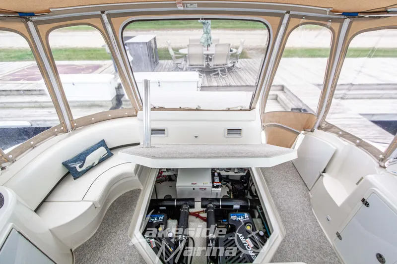 Slide: The Image of 2006 Cruisers Yachts 420 Express interior with engine compartment open, showcasing seating and decor. - 123