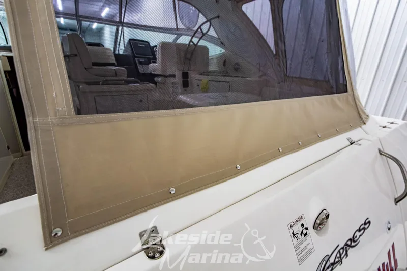 Slide: The Image of 2006 Cruisers Yachts 420 Express interior view with protective cover, docked at Lakeside Marina. - 132
