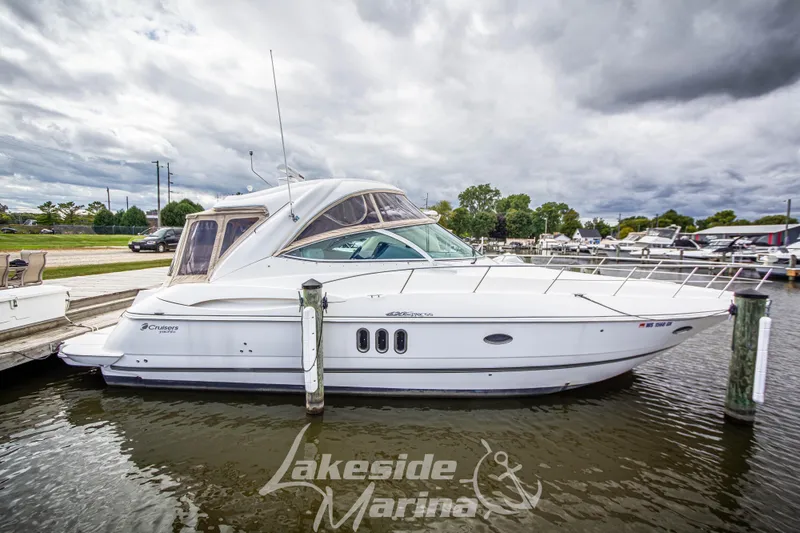 Slide: The Image of 2006 Cruisers Yachts 420 Express docked at Lakeside Marina under cloudy skies. - 14
