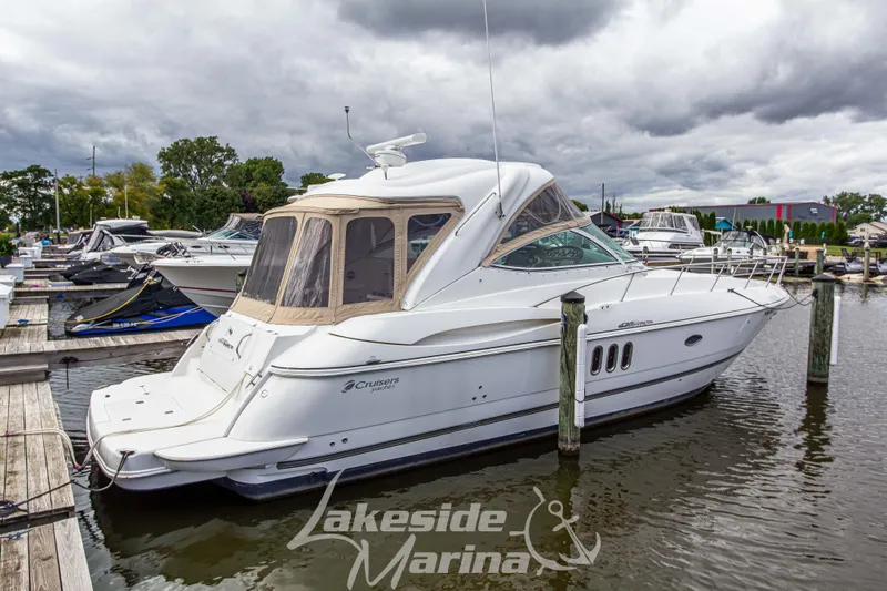 Slide: The Image of 2006 Cruisers Yachts 420 Express docked at marina under cloudy sky. - 15