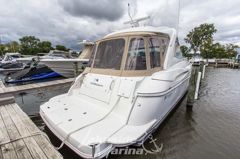Slide: The Image of 2006 Cruisers Yachts 420 Express docked at marina under cloudy skies. - 16
